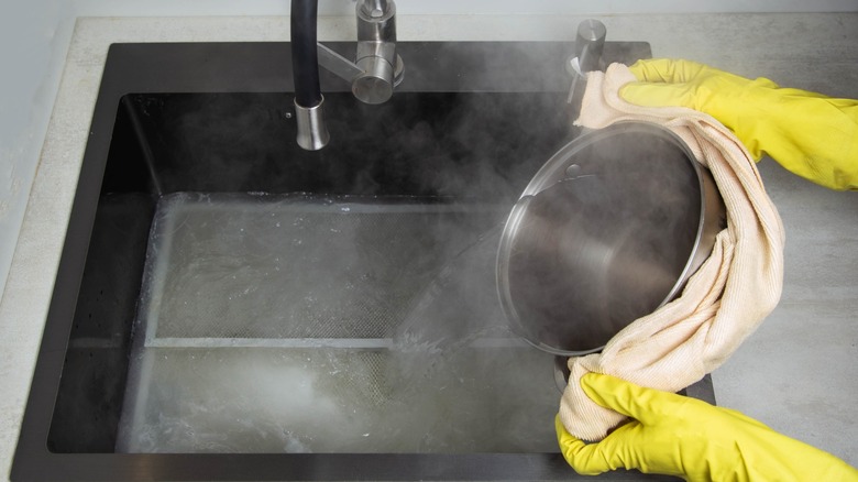 pouring hot water into kitchen sink
