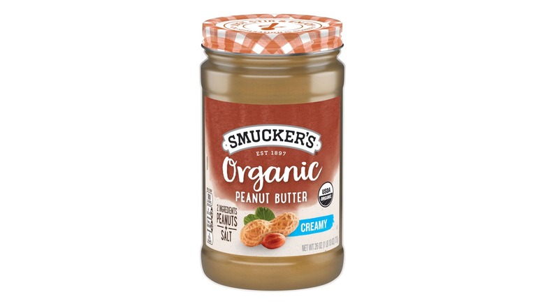 jar of organic creamy peanut butter with gingham lid