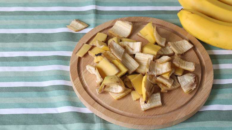 Chopped banana peels on wood cutting board