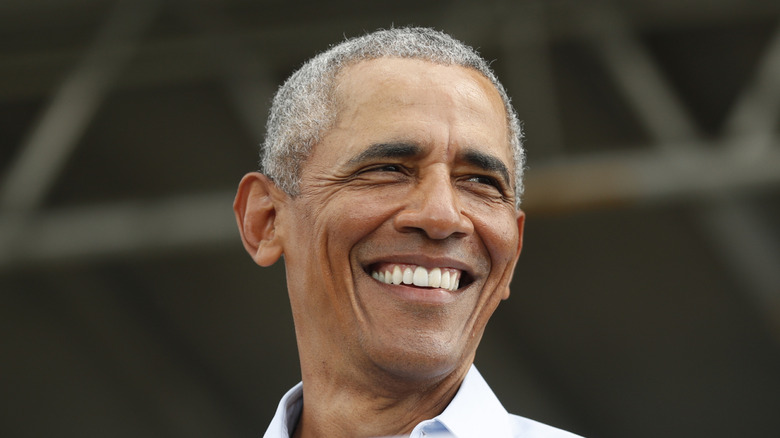 Barack Obama smiling while giving speech