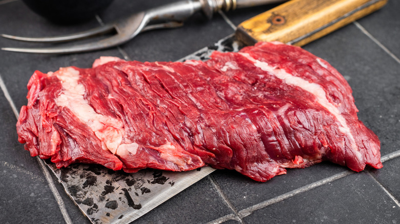 Raw bavette flap steak on a cleaver
