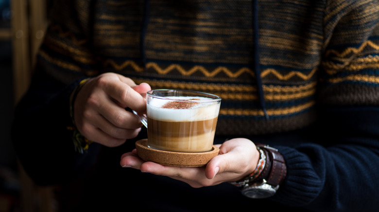 Cup of coffee with a thick white layer of milk foam