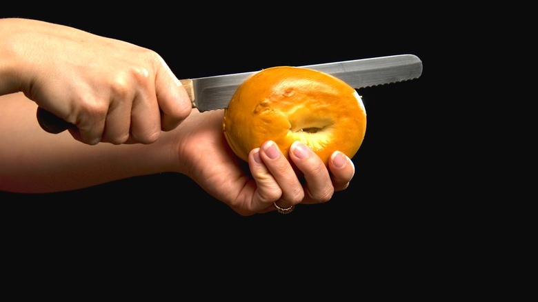 a hand cuts a bag in an unsafe way