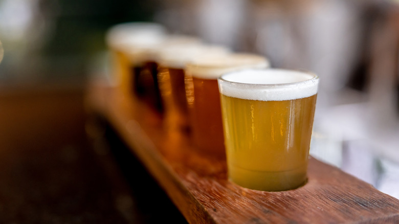 Beer tasting samples on a wooden tray