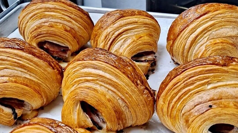 baking sheet with freshly baked ham and cheese croissants