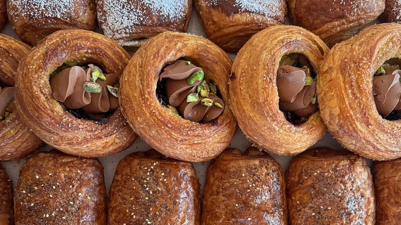Lineup of freshly baked laminated pastries on baking tray
