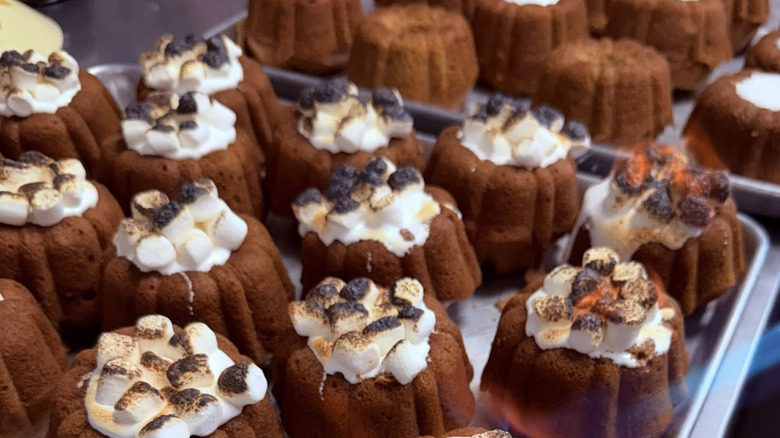 Small Bundt cakes with marshmallows being torched with blowtorch
