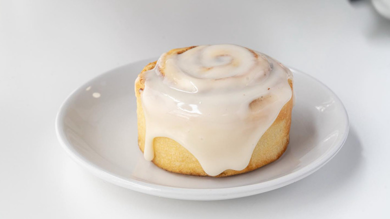 White plate with iced cinnamon roll