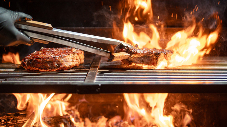 Steak cooked over an open grill flame