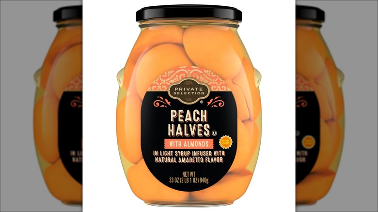 A glass jar of Private Selection Peach Halves with Almonds
