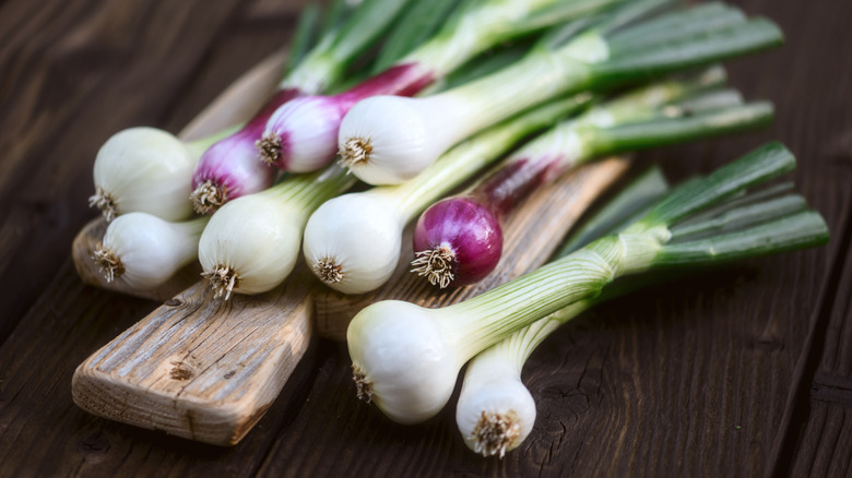 Scallions on a wooden board