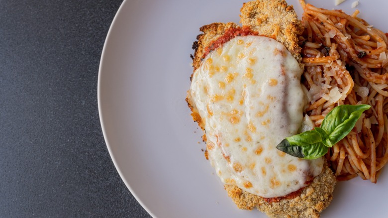 elegantly-plated chicken parm with spaghetti side