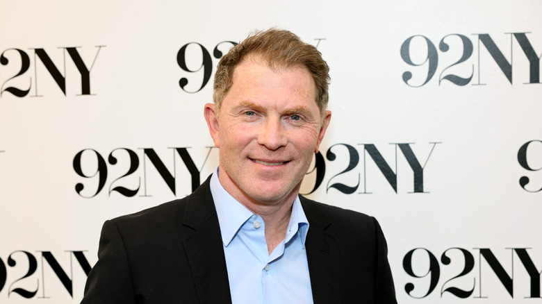 Bobby Flay smiling in dark jacket