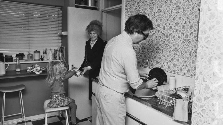family makes dinner in 1970s kitchen