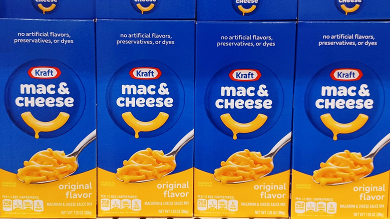 Kraft macaroni and cheese stacked on a grocery store shelf