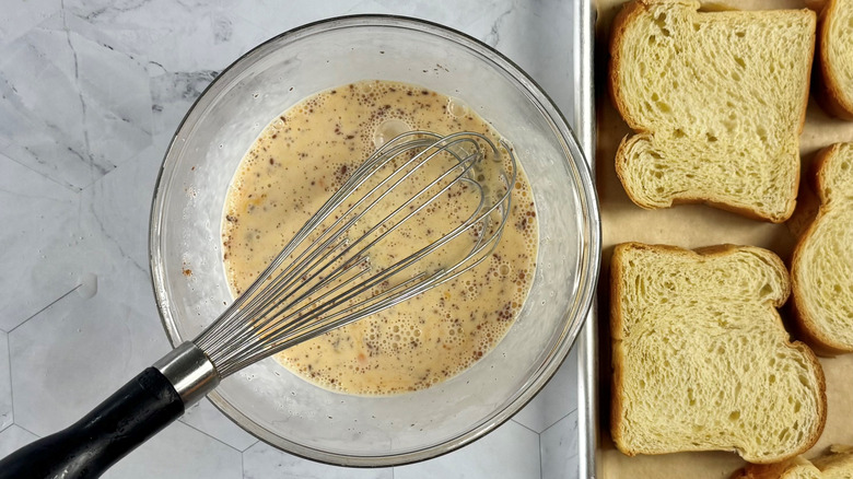 whisking egg and cream mixture in bowl