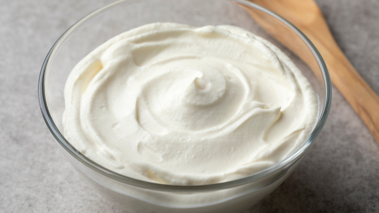 Glass bowl of swirled creme fraiche.