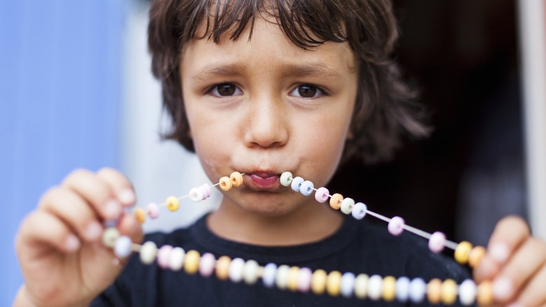 kid with candy necklace