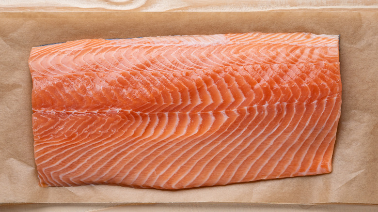 Top-down view of a fillet of salmon on parchment paper