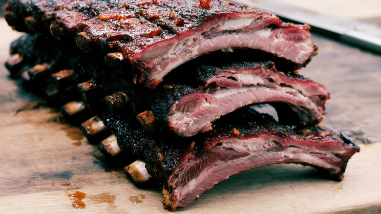 three racks of smoked pork ribs on board