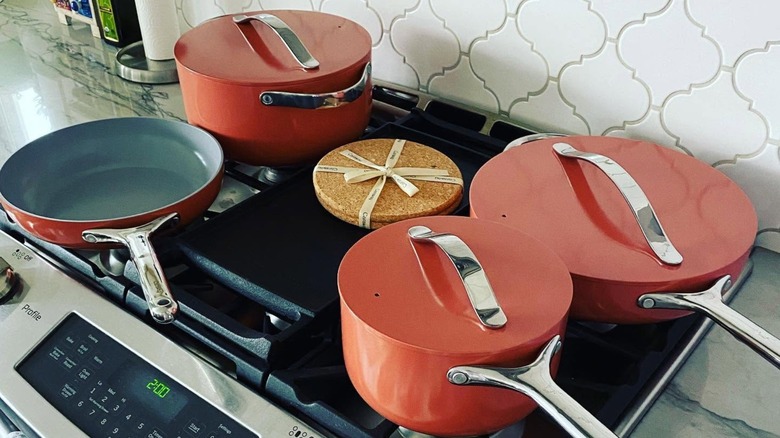 set of pink caraway cookware on stovetop