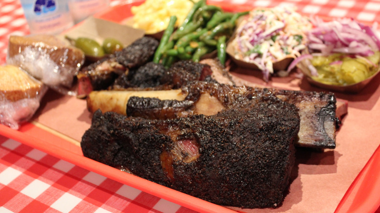 Texas beef ribs on red platter with sides