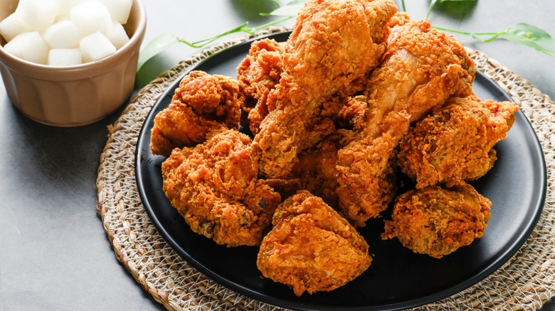 fried chicken plate on woven charger