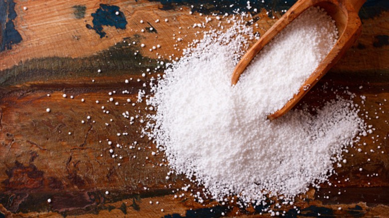 tapioca flour on wooden spoon spilling on tabletop