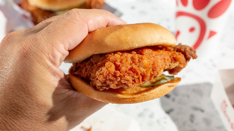 hand holds chick-fil-a sandwich