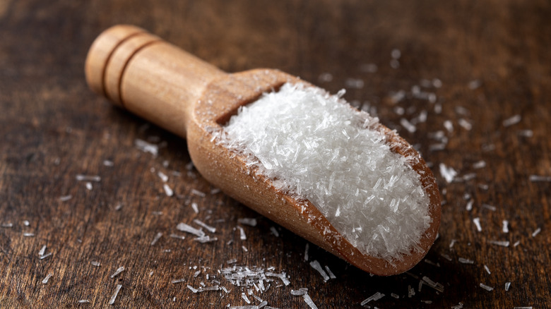 MSG white crystals n a wooden scoop