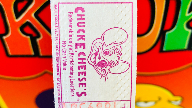 Close up Chuck E Cheese's tickets being dispensed from a video game.
