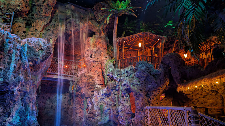 Interior of Casa Bonita restaurant showing waterfall with nearby seating, 2015