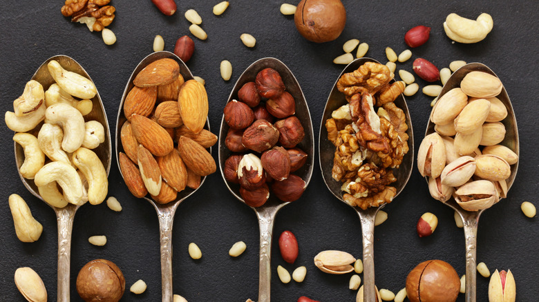 Spoons filled with different kinds of nuts