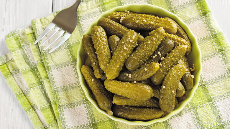 Small bowl of cornichon gherkins.