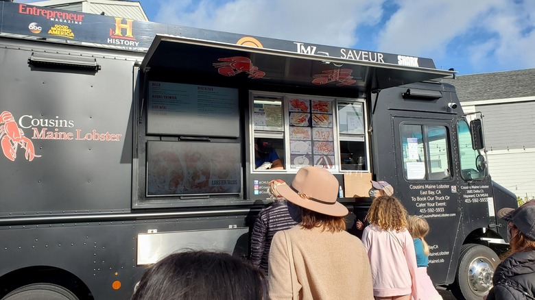 People waiting in line at a Cousins Maine Lobster food truck