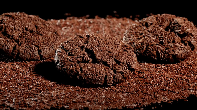 Chocolate Sprinkle Crumbl cookies on pile of chocolate sprinkles