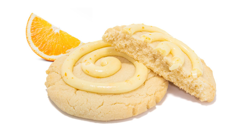 One and a half Orange Roll cookies with orange wedge