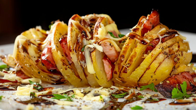 Accordion potato dressed with various toppings.