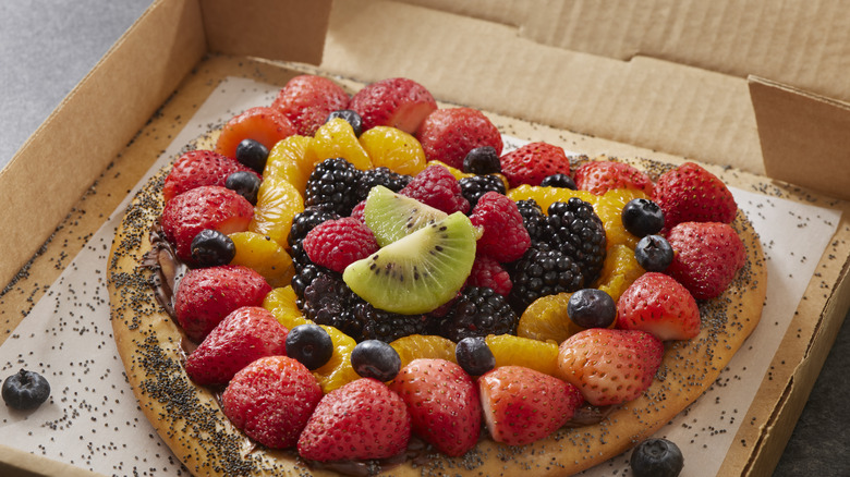 Fruit and chocolate spread pizza in a box