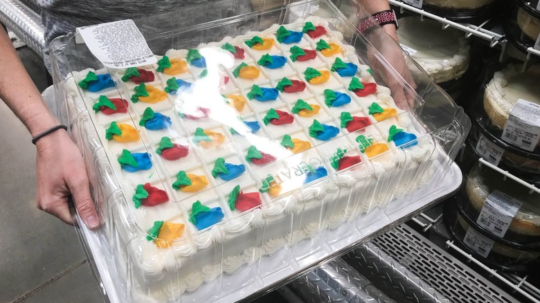 Someone holding a Costco half sheet cake