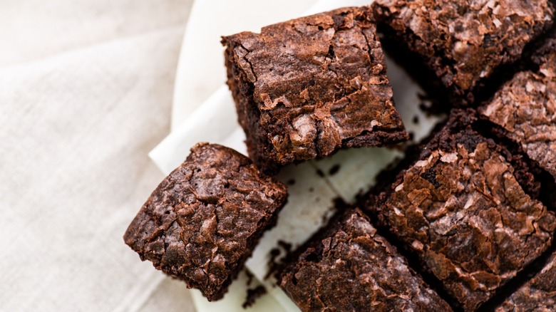brownie squares atop parchment paper