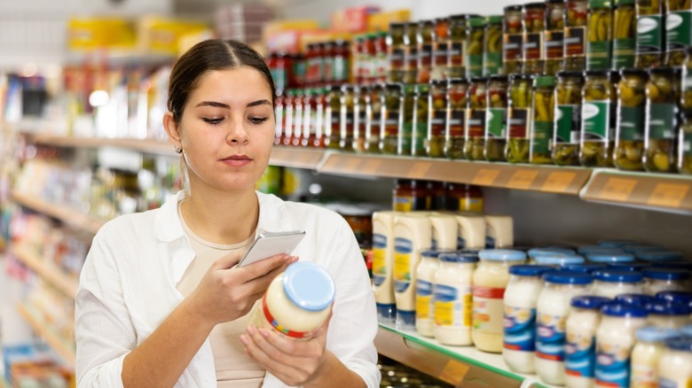 shopper scans bottle of mayo with phone
