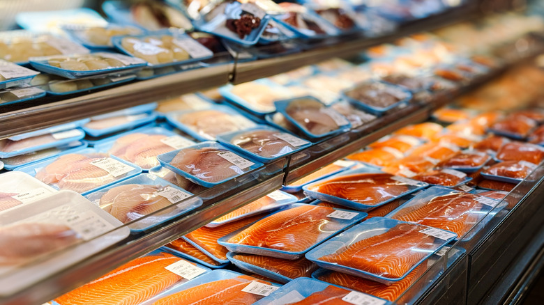 frozen and fresh fish display at grocery store