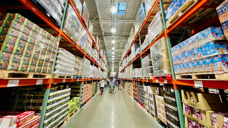 Shoppers in interior aisle of Costco grocery store.