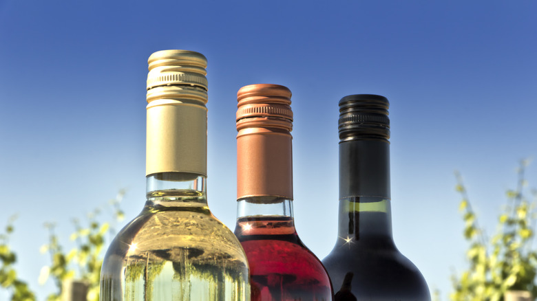 three wine bottles with screw tops