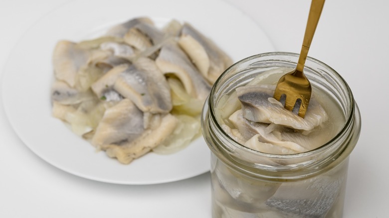 pickled herring on a plate with fork