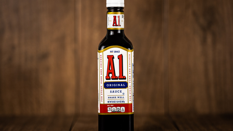 Bottle of A1 steak sauce with wooden background