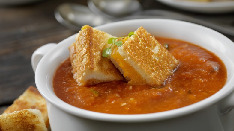 tomato soup with grilled cheese croutons in cup