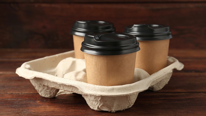 Beverage cups with lids in cardboard drink holder