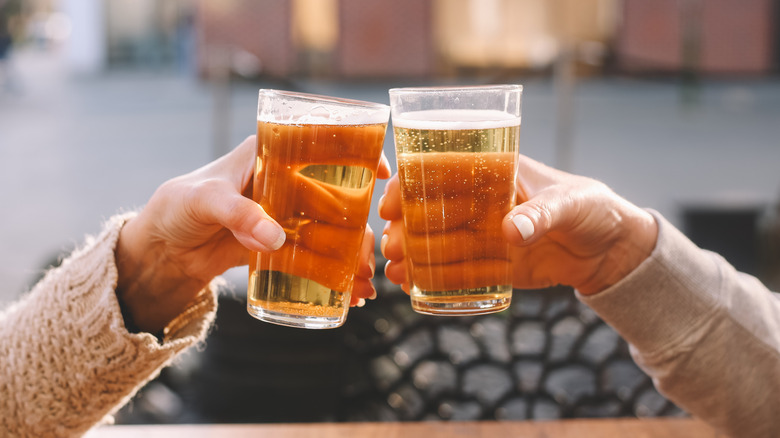 hands toasting with glasses of beer
